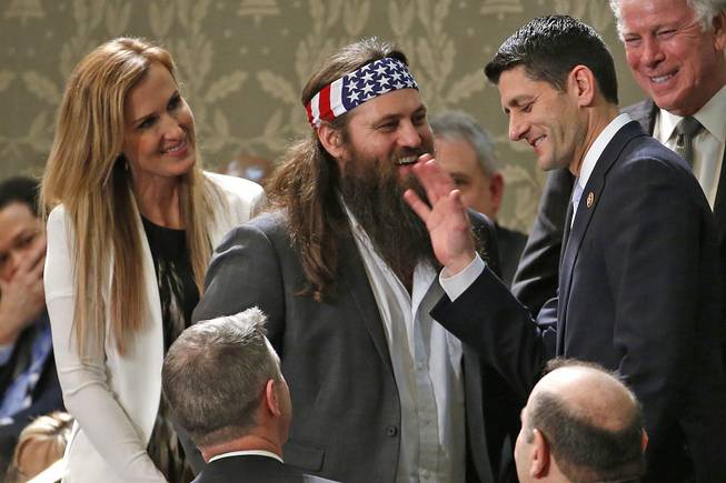 “Duck Dynasty's” Willie Robertson, center, and his wife Korie talk with Rep. Paul Ryan, R-Wis., before President Barack Obama's State of the Union address Tuesday, Jan. 28, 2014, on Capitol Hill in Washington, D.C.