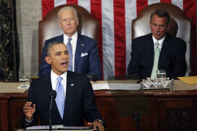 President Barack Obama gives his State of the Union address on Capitol Hill in Washington, Tuesday Jan. 28, 2014, as Vice President Joe Biden and House Speaker John Boehner of Ohio, listen. 