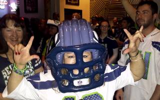 A Seahawks fan poses for the camera during the Seahawks vs. Saints playoff game at Scooter's Pub Jan. 11, 2014.