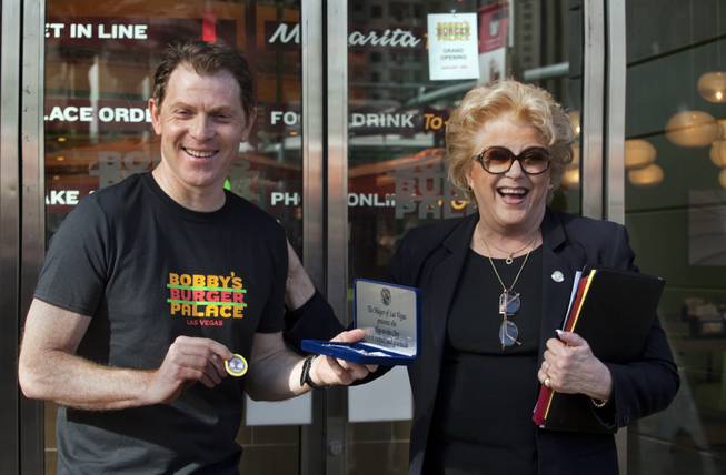 Chef Bobby Flay is presented with a Key to the City by Mayor Carolyn Goodman at the ribbon-cutting ceremony of his Bobby’s Burger Palace on Wednesday, Jan. 29, 2014, on the Strip in Las Vegas.