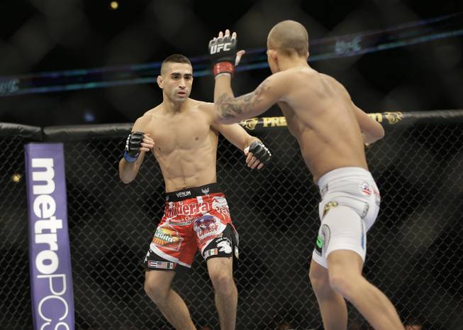 Ricardo Lamas, left, fights Erik Koch during UFC Featherweight Championship on FOX 6 at the United Center in Chicago, Saturday, Jan. 26, 2013. Lamas won the bout.