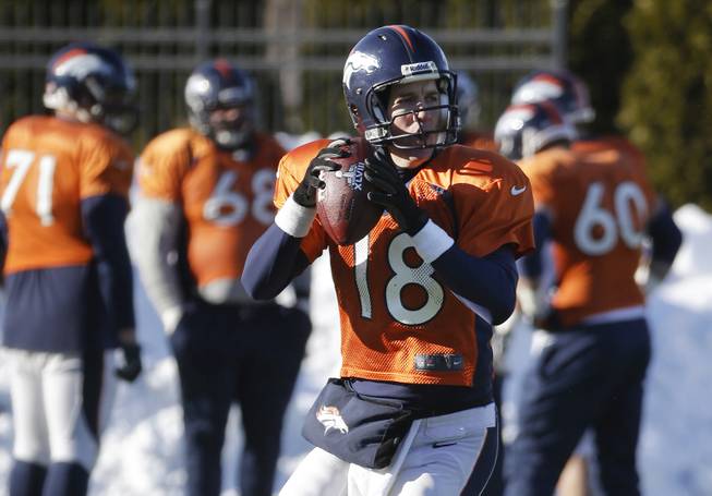 Denver Broncos quarterback Peyton Manning (18) passes during practice Wednesday, Jan. 29, 2014, in Florham Park, N.J. The Broncos are scheduled to play the Seattle Seahawks in the NFL Super Bowl XLVIII football game Sunday, Feb. 2, in East Rutherford, N.J. 