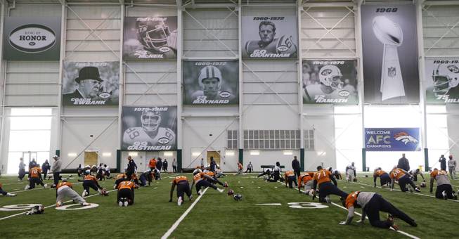Denver Broncos players stretch during practice at the New York Jets facility Thursday, Jan. 30, 2014, in Florham Park, N.J. The Broncos are scheduled to play the Seattle Seahawks in the NFL Super Bowl XLVIII football game Sunday, Feb. 2, in East Rutherford, N.J. 