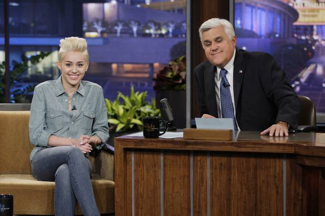 This Jan. 30, 2014, photo provided by NBC shows Miley Cyrus, left, during an interview with host Jay Leno, on "The Tonight Show with Jay Leno." Leno, who took over the "Tonight Show" in 1992, will host his final episode on Thursday, Feb. 6, 2014. (AP Photo/NBC, Paul Drinkwater)