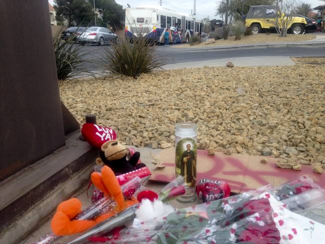 Vehicles and pedestrians travel past a makeshift memorial on Tropicana Avenue at Rainbow Boulevard. The memorial marks the spot where Cleottus Harvey was gunned down by a fellow motorist on Jan. 21. Police are urging witnesses to come forward with information about the shooting.