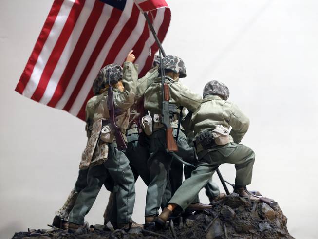 In this Jan. 31, 2014, photo, G.I. Joe action figures portray Raising the Flag on Iwo Jima in a display at the New York State Military Museum in Saratoga Springs, N.Y. A half-century after the 12-inch doll was introduced at a New York City toy fair, the iconic action figure is being celebrated by collectors with a display at the military museum, while the toy's maker plans other anniversary events to be announced later this month.