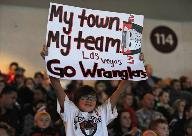 Las Vegas Wranglers fan Emily Adams, 10, holds up a sign she made in support of the home team as they faced off against the Ontario Reign on Friday night at the Orleans Arena.