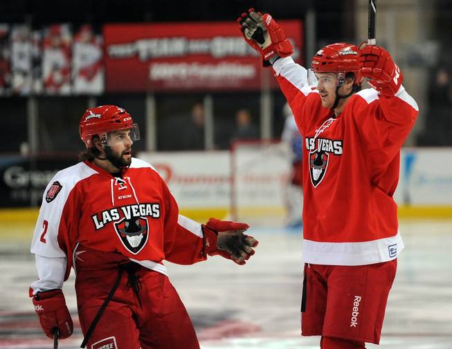 Las Vegas Wranglers center Justin Bernhardt, right, celebrates with teammate Nick Wheeler (2) after scoring his second goal of the game against the Ontario Reign on Friday night.