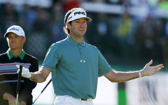 Bubba Watson urges the crowd to cheer after his tee shot at the 16th hole during the third round of the Phoenix Open golf tournament Saturday, Feb. 1, 2014, in Scottsdale, Ariz. 