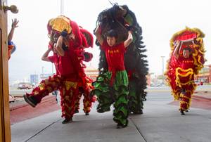 Lion dancers perform outside the Kung Fu Thai & Chinese Restaurant, 3505 S. Valley View Blvd. Sunday, Feb. 2, 2014. The traditional ceremony, performed by the Lohan School of Shaolin, was staged to drive out any evil spirits from the business.