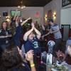 Fans cheer a play by the Seattle Seahawks as they watch Super Bowl XLVIII from Scooters Pub, 6200 S. Rainbow Blvd., Sunday, Feb. 2, 2014.