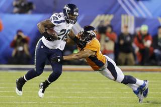 Seattle Seahawks' Michael Robinson tries to get past Denver Broncos' Paris Lenon during the first half of the NFL Super Bowl XLVIII football game Sunday, Feb. 2, 2014, in East Rutherford, N.J. (AP Photo/Ben Margot)