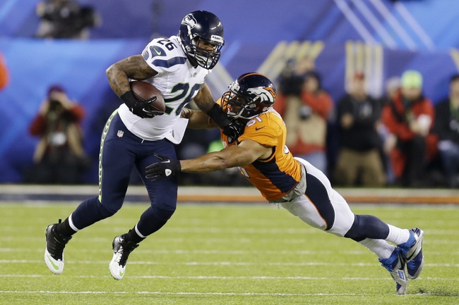 Seattle Seahawks' Michael Robinson tries to get past Denver Broncos' Paris Lenon during the first half of the NFL Super Bowl XLVIII football game Sunday, Feb. 2, 2014, in East Rutherford, N.J. (AP Photo/Ben Margot)