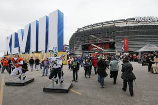 Fans pose for photographs as they arrive at MetLife Stadium before the NFL Super Bowl XLVIII football game between the Seattle Seahawks and the Denver Broncos on Sunday, Feb. 2, 2014, in East Rutherford, N.J. (AP Photo/Matt York)