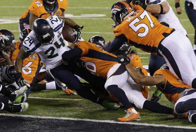 The Seattle Seahawks' Marshawn Lynch (24) runs into the end zone for a touchdown during the first half of Super Bowl XLVIII against the Denver Broncos on Sunday, Feb. 2, 2014, in East Rutherford, N.J.