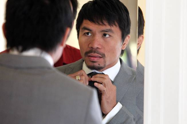 Feb.  3, 2014, Beverly Hills ,Ca.   ---  Manny Pacquiao adjusts his tie during a commercial shoot in Beverly Hills Monday for his upcoming rematch with undefeated WBO World Welterweight  champion Timothy Bradley.  Both fighters will announce their eagerly-anticipated rematch during a two-city media tour that will include press conference stops in Los Angeles on Tuesday and New York on Thursday.  Pacquiao vs. Bradley 2 will take place, Saturday, April 12 at the MGM Grand Garden Arena in Las Vegas. Chris Farina - Top Rank
