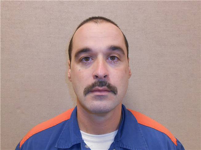 This Feb. 11, 2013, photo provided by the Michigan Department of Corrections shows Michael David Elliot. Elliot, who is serving life behind bars for murder in four 1993 deaths in Michigan, has escaped from prison and may have abducted a woman before she got away in Indiana, according to officials. Michigan Department of Corrections spokesman Russ Marlan says in an email that 40-year-old Elliot was discovered missing about 9:30 p.m. Sunday, Feb. 2, 2014, from the Ionia Correctional Facility in mid-Michigan.