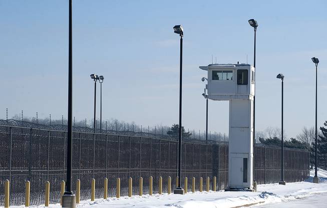 A guard tower stands over fencing at the Ionia Correctional Facility, Monday, Feb. 3, 2014. Convicted killer Michael Elliot escaped from the prison on Sunday. 