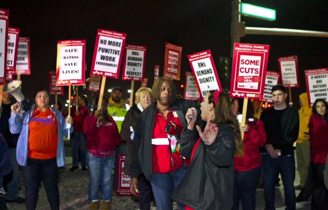 St. Rose Dominican Hospital RN Elizabeth Bickle speaks alongside the National Nurses United Representative Leslie Curtis to motivate the RNs and supporters picketing outside the hospital in Henderson Tuesday, Feb. 4, 2014. 