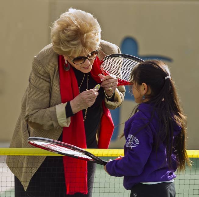 Las Vegas Mayor Carolyn G. Goodman presents Natalie Cheong, 9, with her token after a few volleys at the Darling Tennis Center on Tuesday, Feb. 04, 2014.  The mayor was on hand to announce the arrival of the Las Vegas Neon of the Mylan World Team Tennis here.