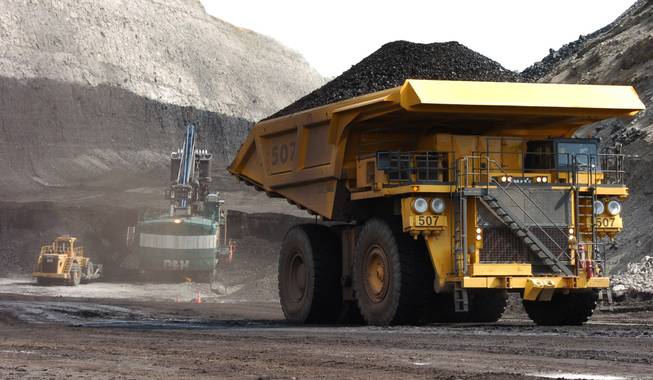 In this April 4, 2013, file photo, a truck carrying 250 tons of coal hauls the fuel to the surface of the Spring Creek mine near Decker, Mont. Congressional investigators have found problems with federal coal sales that a federal lawmaker says potentially cost taxpayers $200 million or more in lost revenue.