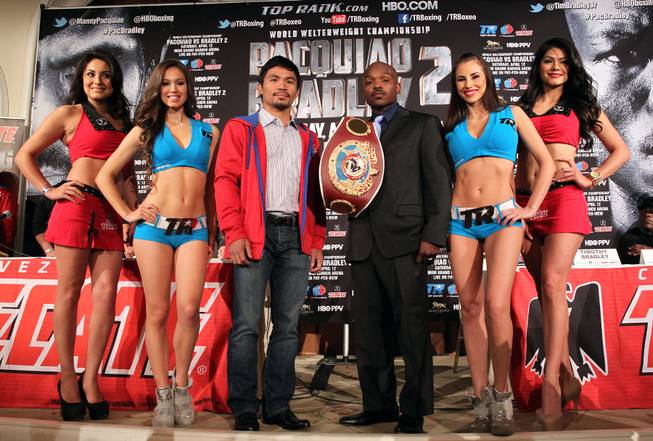 Feb.  4, 2014, Beverly Hills ,Ca.   ---  (L-R)  Manny Pacquiao and undefeated WBO World Welterweight  champion Timothy Bradley(surrounded by the Top Rank Knockouts and Tecate Girls)  pose during the press conference  in Beverly Hills to announce their upcoming rematch during a two-city media tour in Los Angeles on Tuesday and New York on Thursday.  Pacquiao vs. Bradley 2 will take place, Saturday, April 12 at the MGM Grand Garden Arena in Las Vegas. Chris Farina - Top Rank