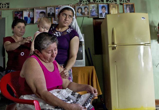 Maria Alvarenga, the mother of Jose Salvador Alvarenga, is comforted by relatives during an interview inside her home in the village of Garita Palmera, El Salvador, Tuesday, Feb. 4, 2014. 