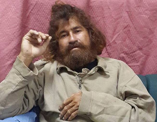 In this Monday, Feb. 3, 2014, photo provided by the Marshall Islands Foreign Affairs Department, a man identifying himself as 37-year-old Jose Salvador Alvarenga sits on a couch in Majuro in the Marshall Islands, after he was rescued from being washed ashore on the tiny atoll of Ebon in the Pacific Ocean. 