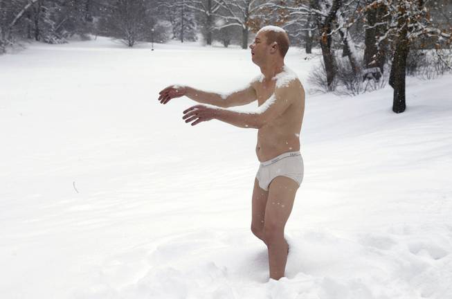A statue of a man sleepwalking in his underpants is surrounded by snow on the campus of Wellesley College, in Wellesley, Mass., Wednesday, Feb. 5, 2014. The sculpture entitled "Sleepwalker" is part of an exhibit by sculptor Tony Matelli at the college's Davis Museum. 