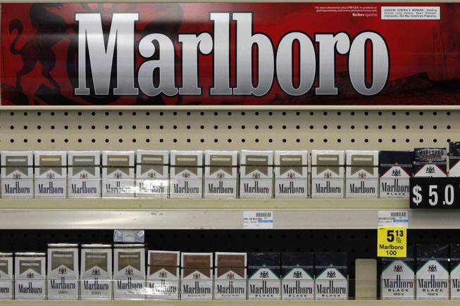 In this Wednesday, July 17, 2013, file photo, Marlboro cigarettes are on display in a CVS store in Pittsburgh. The nation's second-largest drugstore chain says it will phase out cigarettes, cigars and chewing tobacco by Oct. 1 as it continues to focus more on health care. 