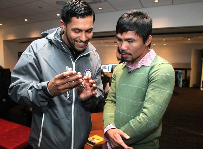 Feb.  5, 2014, New York,NY   ---  "MAKIN' THE ROUNDS" ---  Manny Pacquiao(R) talks with Sochi 2014 Paralympic hopeful, US sled hockey team member Rico Roman during a taping of "SI Now"  at the Sports Illustrated offices in New York City Wednesday. Roman, a US Army veteran, had his left leg amputated after a roadside bomb struck his vehicle during his tour in Iraq in 2007.  Pacquiao vs. Bradley 2 will take place, Saturday, April 12 at the MGM Grand Garden Arena in Las Vegas. Chris Farina - Top Rank