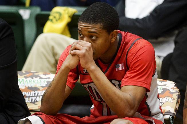 UNLV's Daquan Cook sits on the bench as he watches his team during a 75-57 loss to Colorado State in an NCAA college basketball game Wednesday, Feb. 5, 2014, at Moby Arena in Fort Collins, Colo. 