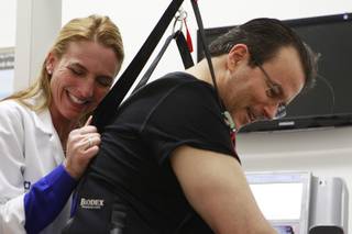 Physical therapist Jen Nash and Kerry Simon laugh while Simon works on a treadmill during a therapy session at the Cleveland Clinic Lou Ruvo Center for Brain Health on Friday, Feb. 7, 2014.