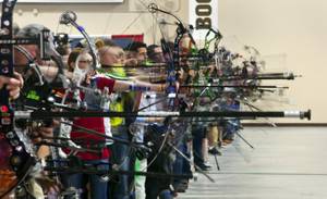 Competitors launch arrows in the practice area of the South Point Arena during the Vegas Round of the 2014 NFAA World Archery Festival on Friday, Feb. 7, 2014.