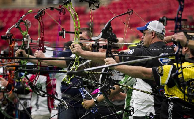 Archers launch arrows during the Adult Freestyle Championship in the South Point Arena as part of the Vegas Round of the 2014 NFAA World Archery Festival on Friday, Feb. 7, 2014.