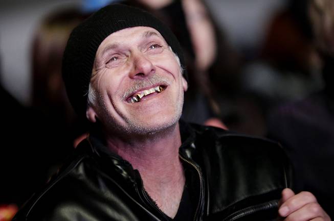 A Russian man reacts as he watches the live telecast of the 2014 Winter Olympics opening ceremony, Friday, Feb. 7, 2014, in downtown Sochi, Russia.