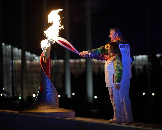 Irina Rodnina and Vladislav Tretiak light the Olympic cauldron during the opening ceremony of the 2014 Winter Olympics in Sochi, Russia, Friday, Feb. 7, 2014.