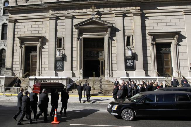 Mourners look on as a casket bearing the remains of Philip Seymour Hoffman is carried into the Church of St. Ingatius Loyola before the actor's funeral Friday, Feb. 7, 2014, in New York.  Hoffman, 46, was found dead Sunday of an apparent heroin overdose.