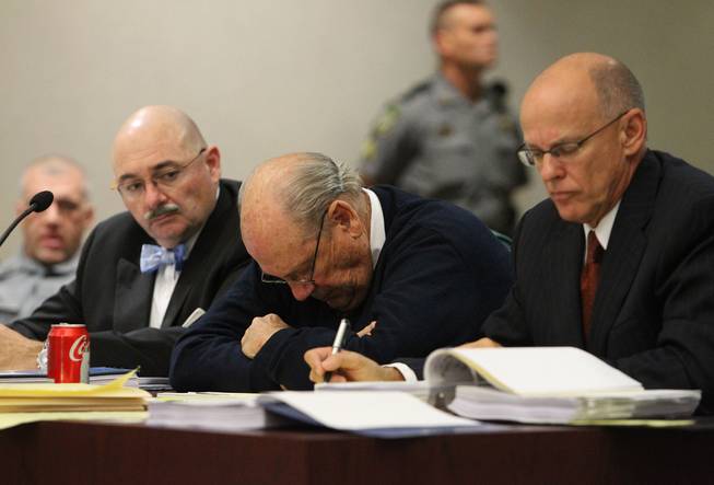 Former Tampa Police Capt. Curtis Reeves Jr., center, sits beside his defense attorneys Richard Escobar, right, and Dino Michaels as they listen to his taped interview by detectives during his bond reduction hearing before Circuit Judge Pat Siracusa at the Robert D. Sumner Judicial Center in Dade City Friday, Feb. 7, 2014.