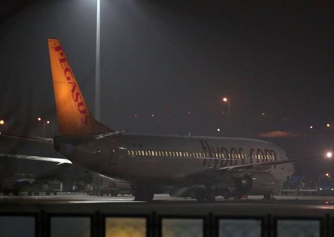 A Pegasus passenger plane at the Sabiha Gokcen Airport in Istanbul, Turkey, Friday, Feb. 7, 2014, after a Ukrainian passenger on an Istanbul-bound flight claimed there was a bomb on board and tried to hijack the plane to Sochi, Russia, where the winter Olympics are kicking off, an official said.