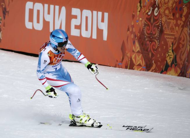 Austria's Matthias Mayer finishes to win the gold in the men's downhill at the Sochi 2014 Winter Olympics on Sunday, Feb. 9, 2014, in Krasnaya Polyana, Russia.