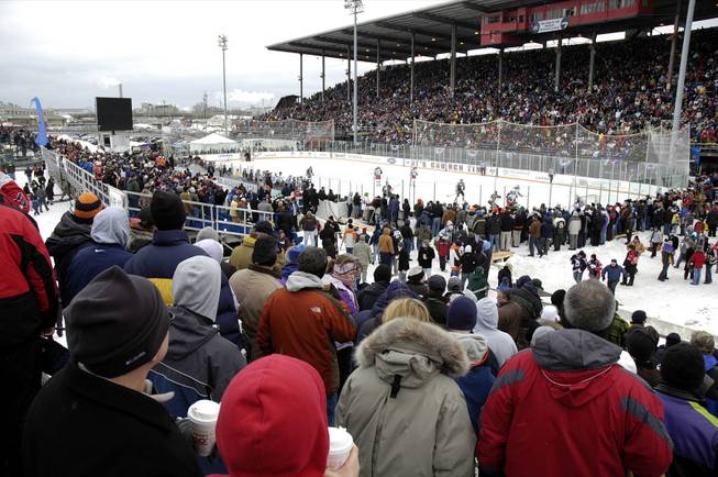 Fans witness the first-ever American League Hockey outdoor game at the New York State Fairgrounds in Syracuse, N.Y., Saturday, Feb. 20, 2010. The Syracuse Crunch hosted the Binghamton Senators in an AHL hockey game.