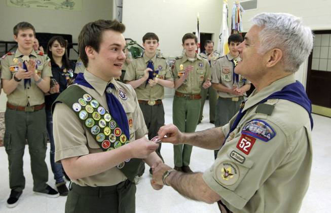 Pascal Tessier, left, a gay Boy Scout, receives his Eagle Scout badge from Troop 52 Scoutmaster Don Beckham, Monday, Feb. 10, 2014, in Chevy Chase, Md. Tessier, of Maryland, has become one of the first openly gay scouts to reach the highest rank of Eagle, following a policy change to allow gay youth in the Boy Scouts of America.