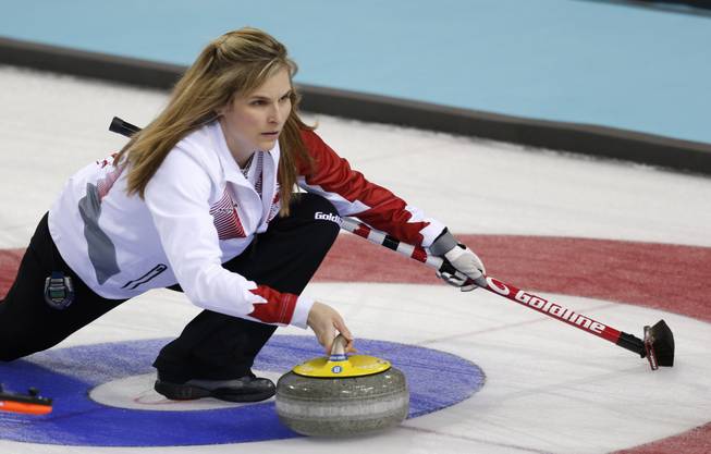Canada’s skip Jennifer Jones delivers the rock to her during women's curling competition against Sweden at the 2014 Winter Olympics, Tuesday, Feb. 11, 2014, in Sochi, Russia.