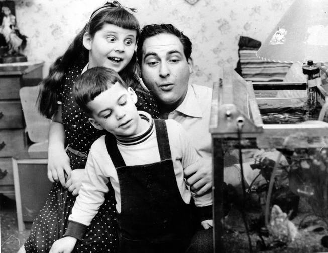 Comedian Sid Caesar is shown at home with his daughter Shelley, 8, and son Richard, 3, on May 25, 1955 at Kings Point, Long Island, N.Y. 