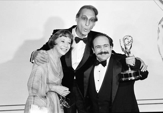 Sid Caesar, center, and Imogene Coca, left, congratulate actor Danny DeVito with his Emmy award at the 33rd annual Primetime Emmy Awards in Pasadena, Ca., Sunday, Sept. 13, 1981.  DeVito won for supporting performance by an actor in the comedy-variety series "Taxi." 