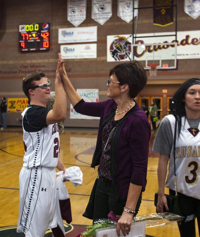 Faith Lutheran senior Clayton Rhodes is congratulated by his mother Shelley for great playing in their basketball game win against Pahrump on Thursday, Feb. 13, 2014.