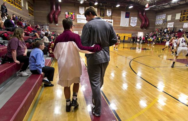 Faith Lutheran seniors Clayton Rhodes and John Molchon walk out onto the court together for their varsity basketball game against Pahrump on Thursday, Feb. 13, 2014.