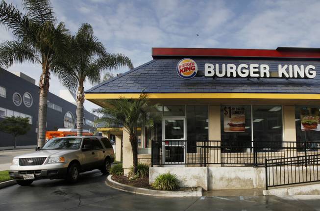 In this Thursday, April 25, 2013, file photo, a car stops at the drive-thru at a Burger King restaurant near downtown Los Angeles.