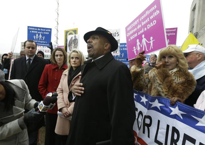 Former Republican lieutenant governor candidate E.W. Jackson, front center, speaks to the media during a demonstration outside federal court in Norfolk, Va., Tuesday, Feb. 4, 2014. Jackson spoke in favor of the law banning same-sex marriage.